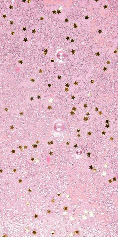 a pink background with gold stars and bubbles