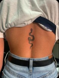 a woman with a tattoo on her lower back