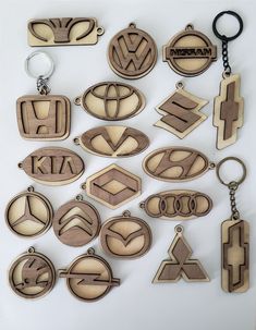 wooden keychains and badges are arranged on a white surface