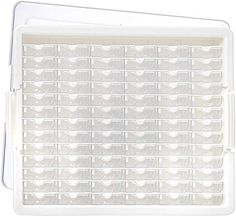 a white plastic tray filled with lots of clear drawers on top of a white surface