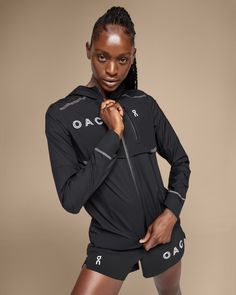 a woman is posing for the camera with her hands on her hips and wearing black shorts