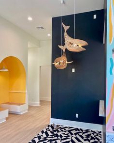 a living room with blue walls and yellow accents on the wall is decorated with gold fish lights