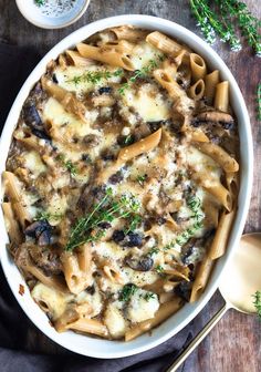 a white bowl filled with pasta and mushrooms