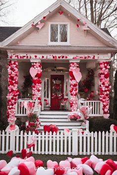 a house decorated for valentine's day with pink and red hearts