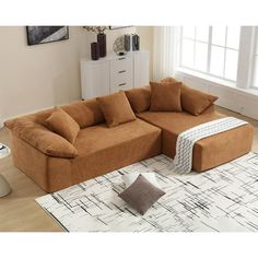 a living room with a sectional couch and rug