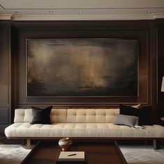 a living room filled with furniture and a large painting on the wall