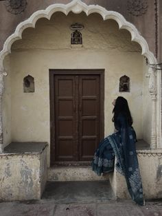 a woman standing in front of a doorway