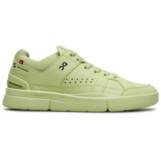 a light green sneaker with white soles and black lettering on the upper part