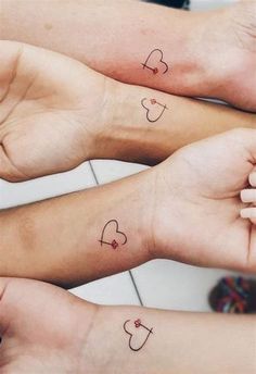 three people with matching tattoos on their arms