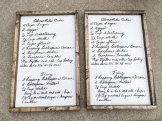 two wooden frames with writing on them sitting next to each other in front of a wall