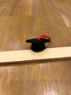 a graduation cap on top of a wooden floor