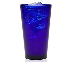 a blue glass filled with ice on top of a table