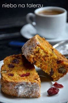 two pieces of cake sitting on top of a white plate next to a cup of coffee