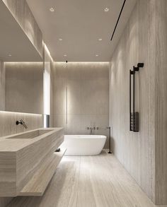 a bathroom with a large white bathtub next to a sink