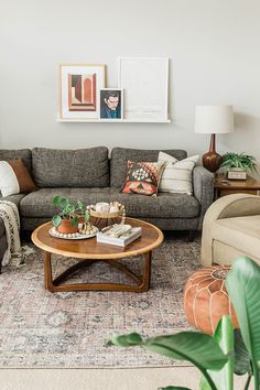 a living room with couches, tables and pictures on the wall above it that says tour boho colorful living room