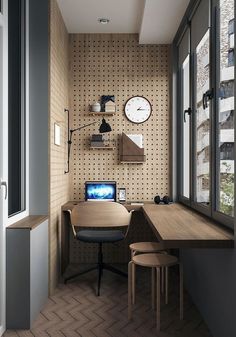 a room with a desk, chair and clock hanging on the wall next to it