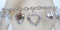 Vintage Italian Jewelry - This is a sterling silver link bracelet loaded with 17 different sizes and styles of heart charms. It is hallmarked 925, signed JCM Mauritius for Jacmel Mauritius, 7.5" long, hearts vary from .38" to .75" in length, weight is 21.2 grams. Sterling Silver Heart Bracelet With Charms, Silver Engraved Heart Charm Bracelet, Silver Heart-shaped Charm Bracelet For Anniversary, Sterling Silver Heart-shaped Engraved Charm Bracelet, Sterling Silver Engraved Heart Bracelet, Engraved Heart-shaped Sterling Silver Charm Bracelet, Silver Heart-shaped Sterling Silver Charm Bracelet, Silver Heart Bracelet With Charms For Anniversary, Silver Heart Bracelets With Dangling Charms