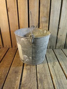 an old bucket sitting on top of a wooden floor