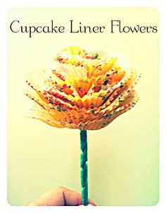 a hand holding up a flower made out of colored pencils with the words cupcake liner flowers on it