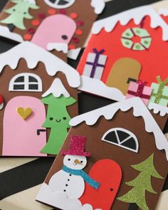 some paper houses that have snowmen on them