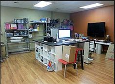 an office with desks, shelves and computers