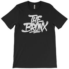 Our original Bronx handstyle graffiti, celebrating The Bronx, NYC, and all it has to offer. Available in sizes Small, Medium, Large, XL, 2XL, 3XL, 4XL, and 5XL. See images for size charts. FREE U.S. SHIPPING * 100% combed and ring-spun cotton * Heather colors are cotton/polyester blend * Slim, stylish unisex fit * Fabric weight: 4.2 oz/yd² (142 g/m²) * Pre-shrunk fabric * Side-seamed construction * Shoulder-to-shoulder taping See our shop to find this design on other styles. This product is made on-demand, just for you, so orders usually take 3-4 business days to ship. Due to our eco-friendly print process, our prints will have a vintage look and feel. Feel free to reach out with any questions. Thanks! All designs are ©(Strange) Allies™, Hopsmash®, and/or Oddhuman®. All rights reserved. Urban Graffiti Print T-shirt For Fans, Fan Merchandise Crew Neck T-shirt With Graffiti Print, Urban T-shirt With Logo Print For Fan Merchandise, Handstyle Graffiti, Bronx Nyc, Size Charts, Bronx, Shoulder Taping, Vintage Looks