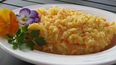 a white plate topped with rice and flowers