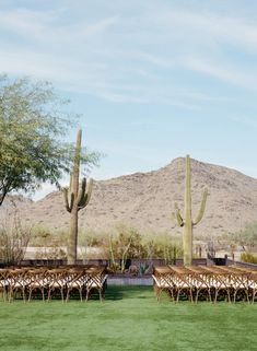 the tables are set up in front of the desert mountain range for an outdoor wedding