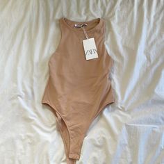 Beige/Tan Chic Beige Stretch Swimwear, Chic Beige Lined Bodysuit, Spring Beige Lined Swimwear, Beige Sleeveless Bodysuit For Beach, Beige Sleeveless Bodysuit For The Beach, Beige Lined Swimwear For Spring, Sleeveless Beige Bodysuit For The Beach, Chic Beige Bodysuit For Spring, Sleeveless Brown Bodysuit For Spring