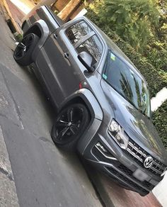 a grey truck parked on the side of a road