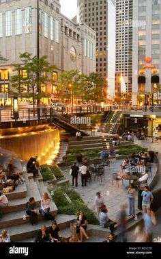 people sitting and walking around in the city at dusk - stock image, public square, chicago, illinois, usa - stock image