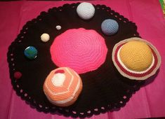 there are crocheted planets on the table