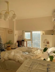 a bed room with a large window and a christmas tree