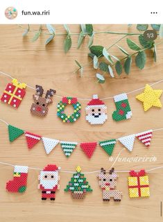 cross stitch christmas decorations hanging on a string