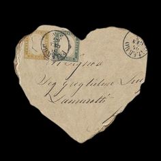 a heart - shaped piece of paper with stamps on it is shown in front of a black background