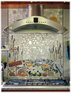 a stove top oven sitting inside of a kitchen next to a wall covered in circles