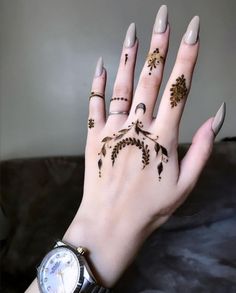 a woman's hand with tattoos on it