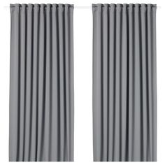 two gray curtains hanging on a white wall