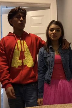 a young man and woman standing next to each other in front of a door with a mcdonald's sign on it