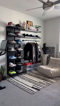 a living room filled with lots of furniture and shelves next to a ceiling mounted fan