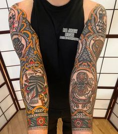 a man with many tattoos on his arms