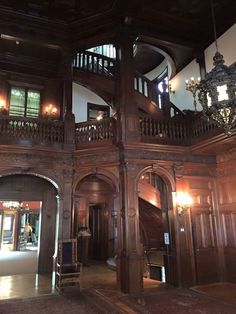 an ornate wooden building with chandeliers on the balconies and staircases