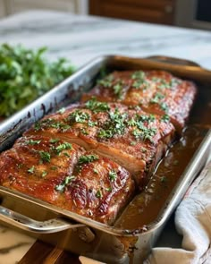 meat in a pan with parsley on top, ready to be cooked and served