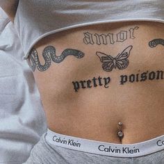 a woman with tattoos on her stomach and the words pretty prison written in black ink