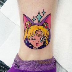 a woman's leg with a tattoo on it that has an image of sailor moon