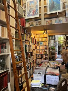 there are many books on the shelves in this room and one person is looking at them