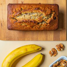 a loaf of banana bread next to some nuts