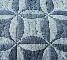 a blue and white quilt with circles on it