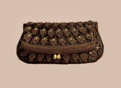 "This lovely vintage bag was hand beaded in Hong Kong, circa 1950's.  The material is a deep brown satin on the outside and the border and the inside is a light chocolate color.  The  design is rows of leaf shapes done in dark brown glass seed beads framed with bugle beads.  The frame of the bag is encrusted in glass seed beads.  The closure is a kiss lock with rhinestones on the ends.  The interior is a medium brown satin with one slip pocket and the Made In Hong Kong tag.  The bag measures  9\ Fold Over Clutch, Bead Frame, Vintage Playing Cards, Brown Satin, Chocolate Color, Bugle Beads, Vintage Bag, Deep Brown, Glass Seed Beads