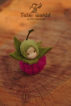 a small stuffed toy sitting on top of a wooden table